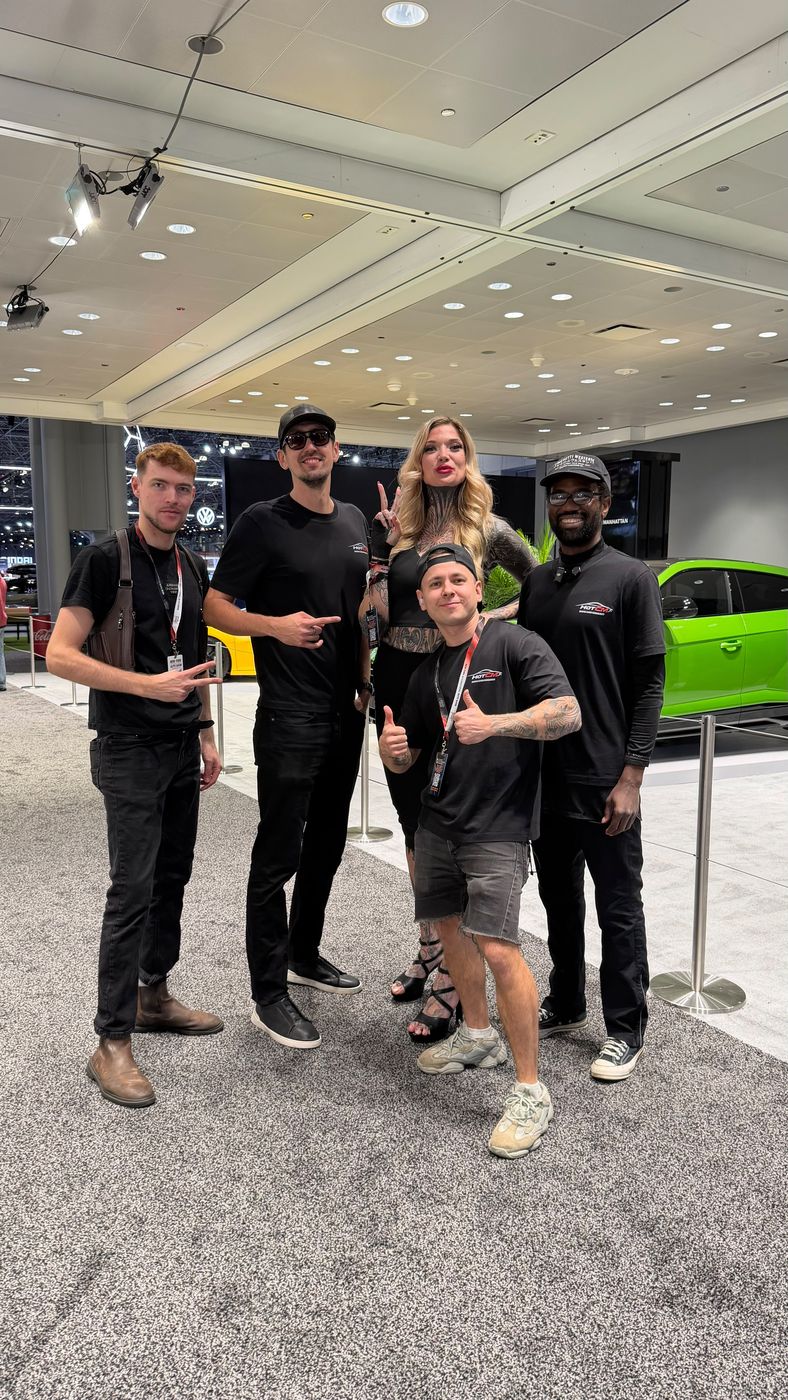Vadim Divakov and the HOTCM team at an auto show