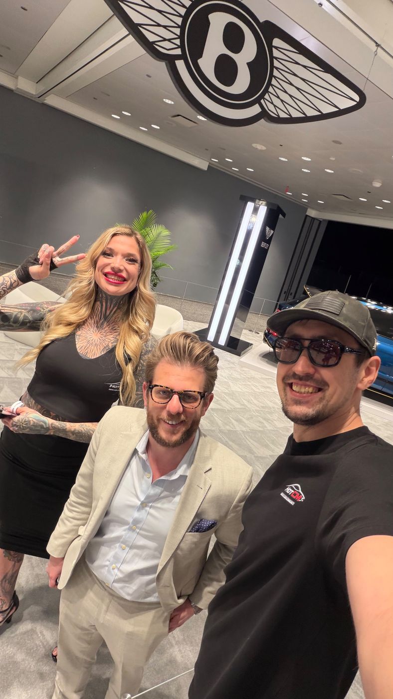 Vadim Divakov with colleagues at a Bentley stand
